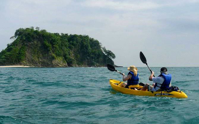 Tourists kayaking towards Isla Chora, a small island near Samara, Costa Rica